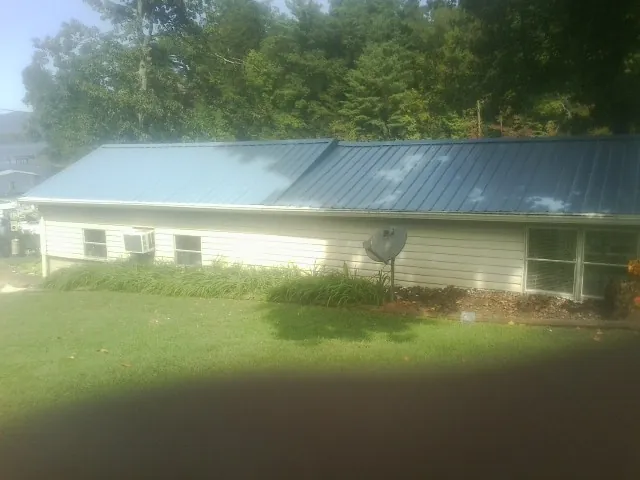 Blue metal roof running the length of a single story home in Five Points